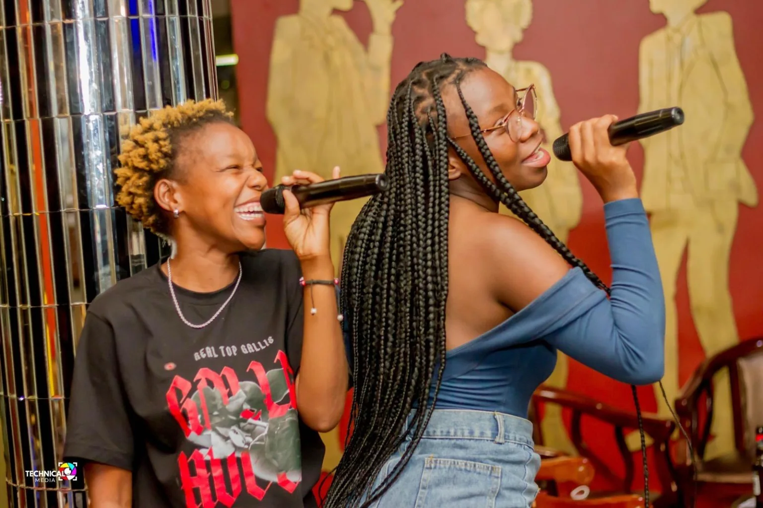 Two guests singing karaoke together